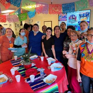 A group of people enjoying a festive celebration with colorful decorations and food.