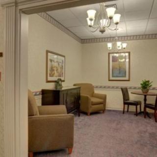 A cozy waiting room with comfortable seating and elegant lighting.