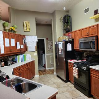 A modern kitchen with wooden cabinets and stainless steel appliances.