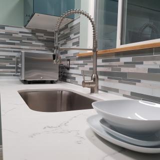 Modern kitchen with a sleek countertop and stylish backsplash.