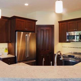 Modern kitchen with stainless steel appliances and wooden cabinets.