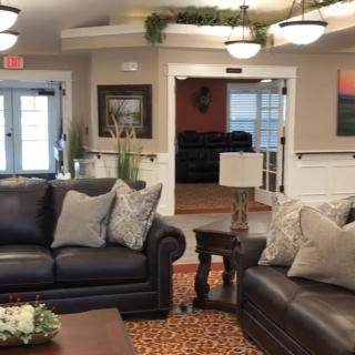 A cozy living room with leather sofas and tasteful decor.