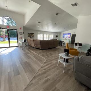 A spacious and bright living room with modern furniture and a large window.