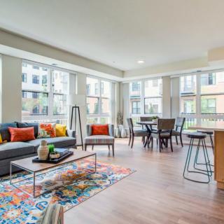 A modern, colorful living room with large windows and open space.
