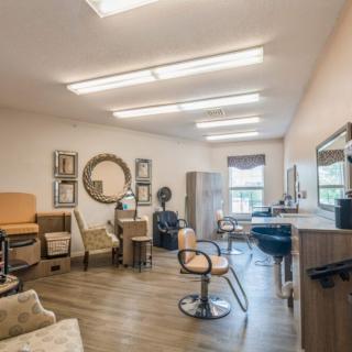 A well-lit hair salon with stylish chairs and mirrors.