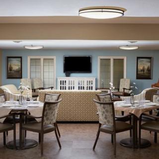 A cozy, well-decorated living room and dining area with a television and comfortable seating.