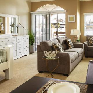 A cozy living room with a modern sofa, dining area, and stylish decor.