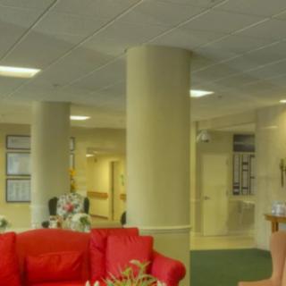 A spacious lobby area with red sofas and large pillars.