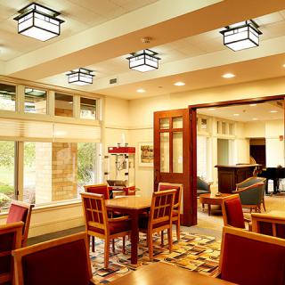 A cozy dining area with wooden furniture and soft lighting.