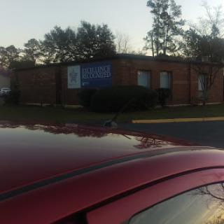 A brick building with signage, captured during the evening.