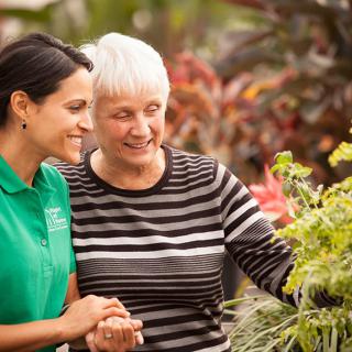 Two women enjoying time together in a garden.