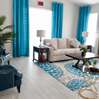 A modern living room with blue accents and stylish furniture.
