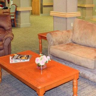 A comfortable lobby area with sofas, a coffee table, and magazines.