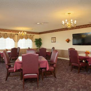 A cozy dining area featuring elegant furnishings and warm lighting, perfect for gatherings.