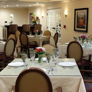 An elegant dining room with neatly set tables and comfortable chairs.
