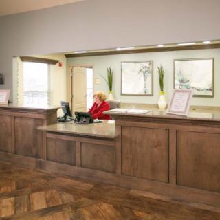 A welcoming reception area with a front desk and a staff member working.