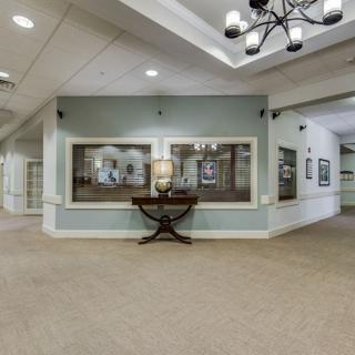 Spacious lobby area with a modern chandelier and artwork on the walls.