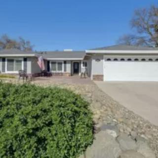 A suburban single-story house with a garage and driveway.