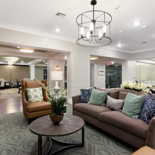 A modern living room with comfortable seating and elegant lighting.