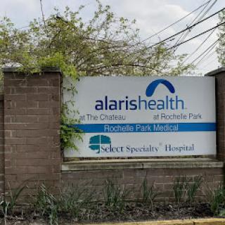 A sign for Alaris Health, a specialty hospital offering comprehensive healthcare services.