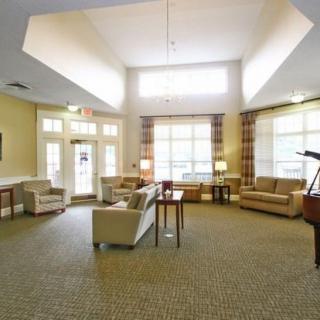 A spacious and well-lit lobby area with comfortable seating and large windows.