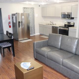 A modern open-plan apartment with a kitchen and living room.