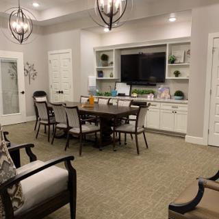 A stylish and modern living space featuring a dining area and entertainment setup.