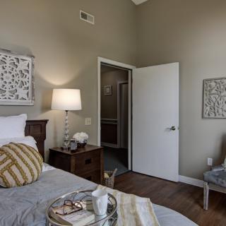 A cozy modern bedroom with stylish decor and warm lighting.