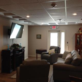 A cozy living room with a sofa, television, and modern decor.