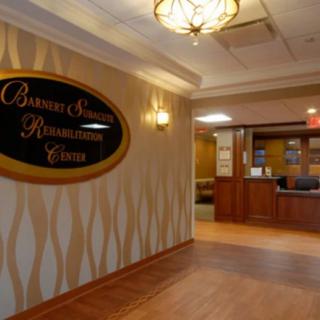 Lobby of a rehabilitation center with a reception desk and signage.