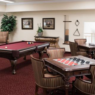 A cozy game room featuring a billiards table and a checkers board for leisure activities.