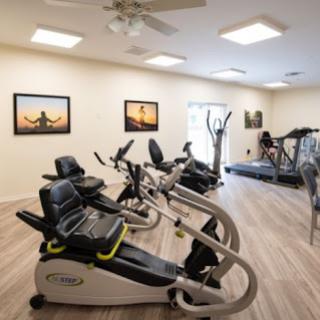 A well-equipped fitness room featuring various exercise machines, perfect for a workout session.