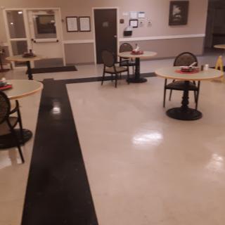 A quiet dining area with empty tables and chairs, showcasing a calm atmosphere.