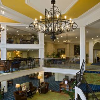 A luxurious and spacious hotel lobby with elegant chandeliers and comfortable seating areas.