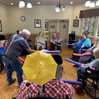 Seniors participating in a fun exercise session at a community center.