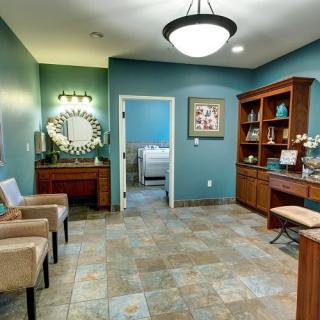 A modern waiting area with comfortable seating, decorative lighting, and a welcoming atmosphere.