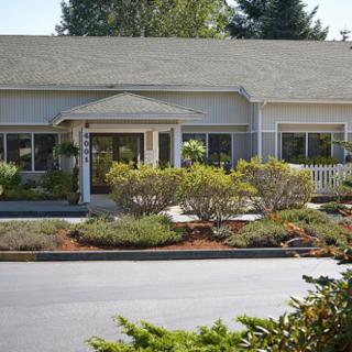 A residential building with well-maintained landscaping and greenery.