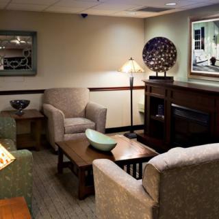 A cozy living room with armchairs, a coffee table, and decorative elements.