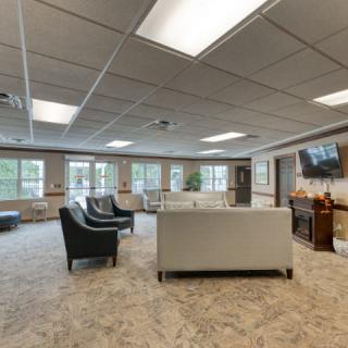 A spacious and modern living room with comfortable seating and ample natural light.