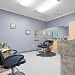 A modern hair salon interior with styling chairs and mirrors.