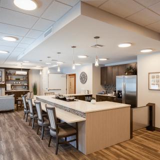 A modern kitchen and dining area featuring bar seating and elegant interior design.