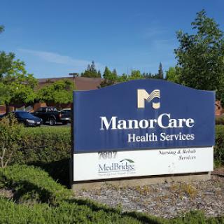 A sign for ManorCare Health Services, indicating the location of a healthcare facility.