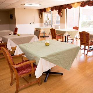 A bright and inviting dining area with neatly arranged tables and chairs.