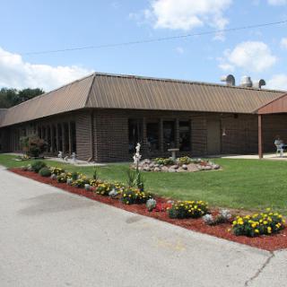A well-maintained building surrounded by a vibrant garden.