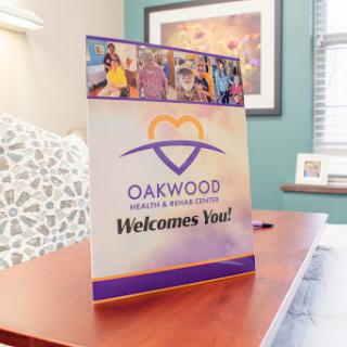 A welcoming sign displayed in a healthcare facility, promoting Oakwood's services.