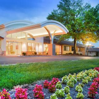 A modern hotel entrance with well-maintained landscaping and vibrant flowers.