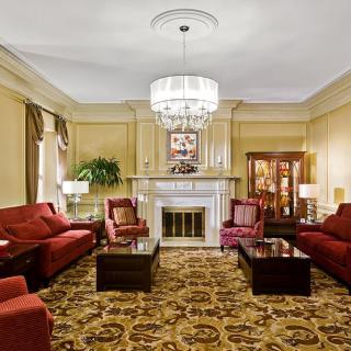 A luxurious classic living room with elegant furnishings and a chandelier.