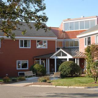 A modern residential building with a welcoming entrance and landscaped surroundings.