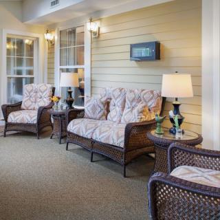 Cozy living room with wicker furniture and soft lighting.
