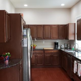 A modern kitchen with wooden cabinets and stainless steel appliances.
